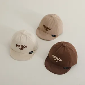 Infant cotton baseball cap with embroidered smiley face and soft brim in three colors