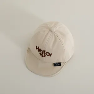 Detailed close-up of soft cotton baby baseball cap with Hello smile embroidery