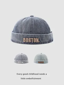 Macro detail of washed denim docker hats in three blue shades with BOSTON embroidery