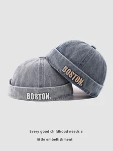 Detailed embroidery of BOSTON text on denim brimless docker hats for children