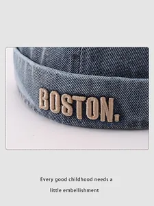 Close-up of light blue denim docker hat featuring white BOSTON 3D embroidery detail