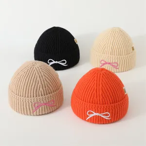 Winter knitted hats for children in multiple colors with sweet bow embroidery