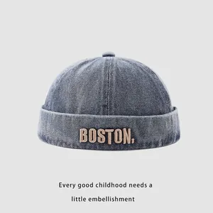 Close-up of Boston embroidery on a dark blue denim docker cap for children