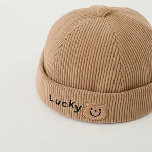 Detail of khaki corduroy texture and Lucky bear embroidery on the kids' skull cap