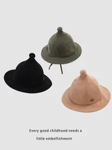 Detailed trio of corduroy pointed bucket hats for kids in green, black, and pink colors