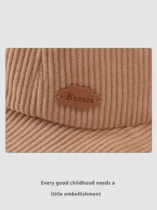 Detail of corduroy fabric texture and leather cloud patch on kids bucket hat