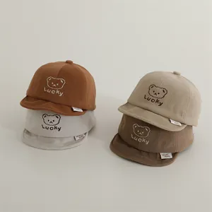 Infant baseball cap with lucky bear embroidery and soft fabric texture in four earthy colors