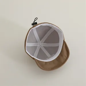 Detail view of baby cap interior showing grey lining, reinforced seams and adjustable toggle