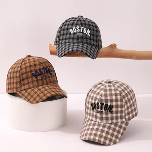 Detailed close-up of plaid kids baseball caps with 3D BOSTON embroidery in autumn colors