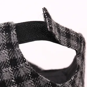 Detail of plaid baseball cap with adjustable Velcro strap and thick wool texture