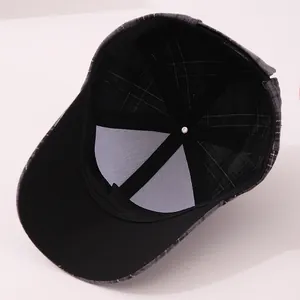 Detailed interior of checkered baseball cap showing black lining and reinforced stitching