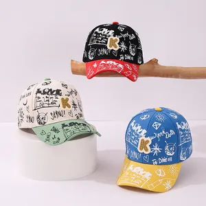 Detailed shot of kids' hip hop baseball caps with graffiti patterns and K letter patch