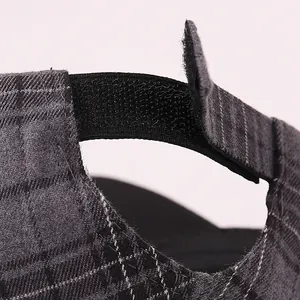 Detail of adjustable velcro strap on grey checkered hip hop baseball cap for kids