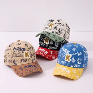 Graffiti style kids baseball caps with K patch in three vibrant color combinations