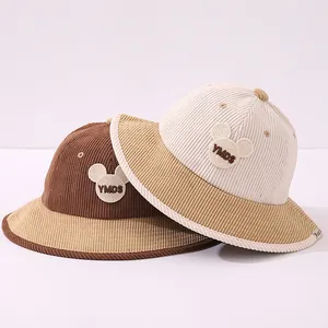 Detail of two corduroy kids bucket hats with bear embroidery and contrast brim