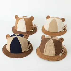 Detailed grid of corduroy kids bucket hats with cute bear ears and bow tie accents