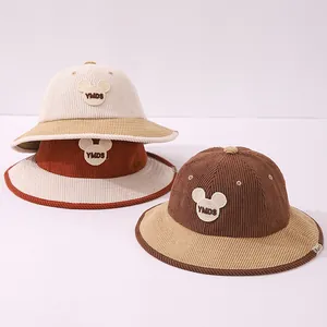 Detail of children's corduroy bucket hats with embroidered bear ears and YMDS patches