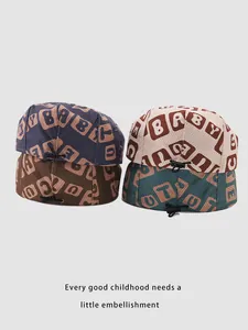 Detail of adjustable drawstring lock on corduroy baby berets with letter prints