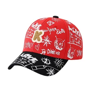 Red kids graffiti baseball cap with black brim and 3D textured K letter patch