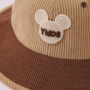 Close-up of corduroy texture and bear embroidery on the toddler fisherman hat