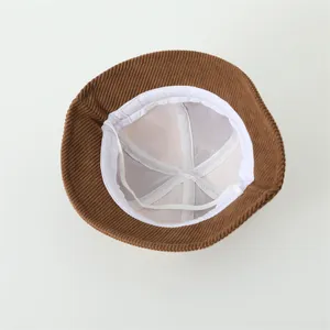 Detailed inner view of corduroy baby bucket hat with mesh lining and chin strap