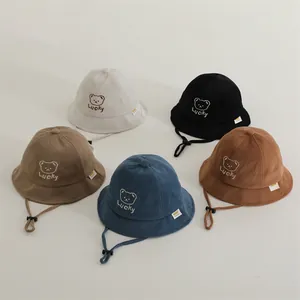 Detail of waffle-textured cotton bucket hats in five colors with cute bear embroidery