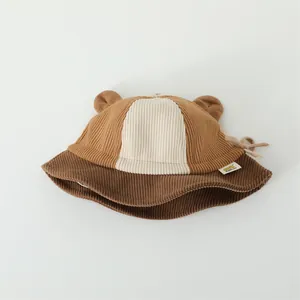 Close-up of children's corduroy bucket hat featuring bear ears and color-block texture
