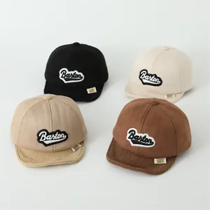 Detail of four colorful toddler baseball caps showing corduroy brim and texture mix