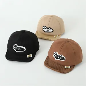 Detailed shot of kids baseball caps in black beige and brown with corduroy brims