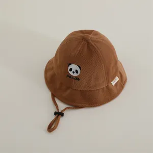 Detail of brown waffle fabric kids bucket hat with panda embroidery and windproof rope