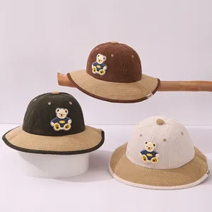 Kids corduroy bucket hat with bear patch in brown, dark green and cream colors