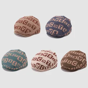 Five vintage baby newsboy caps in various colors with letter prints on corduroy fabric