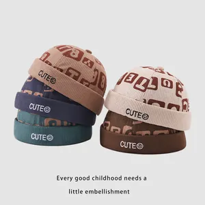 Corduroy children's brimless caps in multiple colors featuring cute smiley embroidery