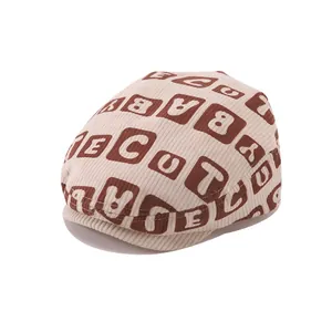 Winter baby corduroy beret hat with cute letter print and short brim on white background