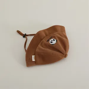 Detail of brown waffle knit bucket hat with panda embroidery and adjustable drawstring