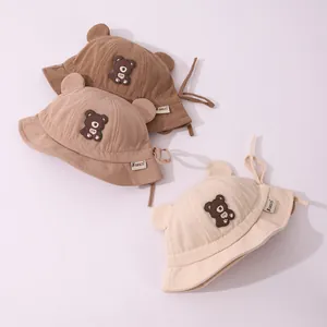 Detailed corduroy fabric texture and cute bear patch on toddler winter bucket hats