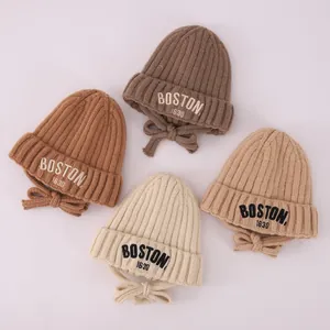 Toddler knitted winter hats with BOSTON letters in four warm colors with earflaps and straps
