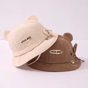 Detailed texture of corduroy baby bucket hats with cute bear ears and nice day patch