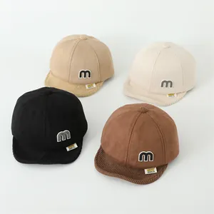 Detail of baby soft brim baseball hats with 3D M letter patch and corduroy textures