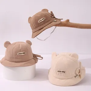Close-up of baby corduroy bucket hats with cute ears and windproof straps in three colors