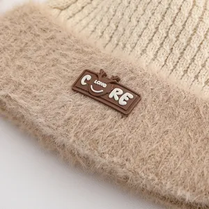 Detailed view of winter knit hat featuring cream textures and a plush brown fleece brim