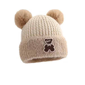 Warm baby winter knit hat with double pom-poms and cute bear embroidery patch