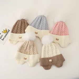 Winter knit hats for kids with plush pom poms and ear flaps in five assorted colors