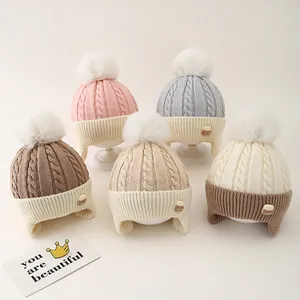 Winter knit beanies for toddlers in five colors with soft pom-poms and ear protection