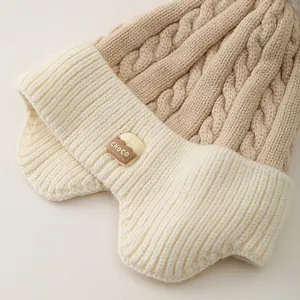 Kids warm knit trapper hat with pom-poms and ear flaps in beige and khaki colors