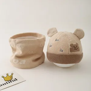 Detail of baby winter knit hat and scarf set with cute bear ears and plush lining