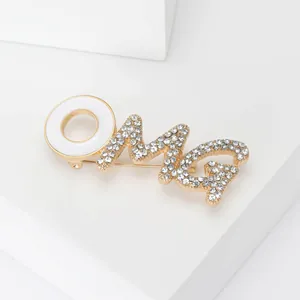 Vintage gold-plated OMG letter brooch with white enamel and sparkling rhinestones