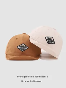 Detail of baby soft brim baseball caps in caramel and cream with mountain patch