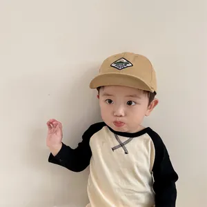 Detail of khaki cotton baby baseball cap with diamond mountain embroidery patch
