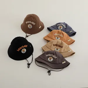 Detail of baby bear bucket hats in six colors with adjustable drawstrings and embroidery